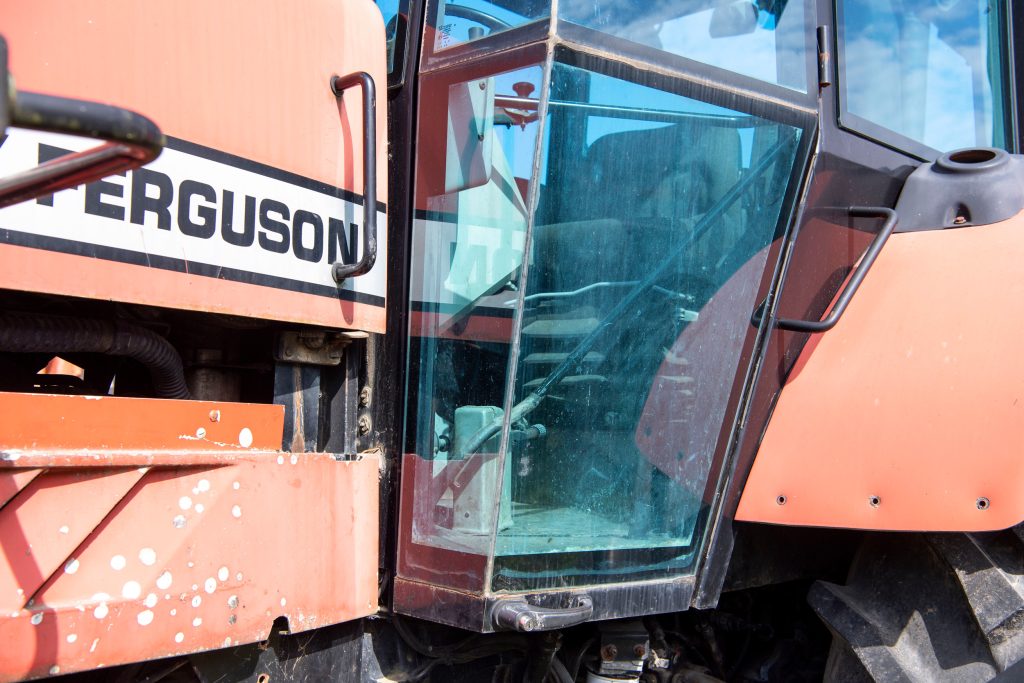 De Massey Ferguson 9240 heeft een opvallende cabine. Dat komt deels door deze deuren met hoekramen erin en de klink helemaal onderaan.