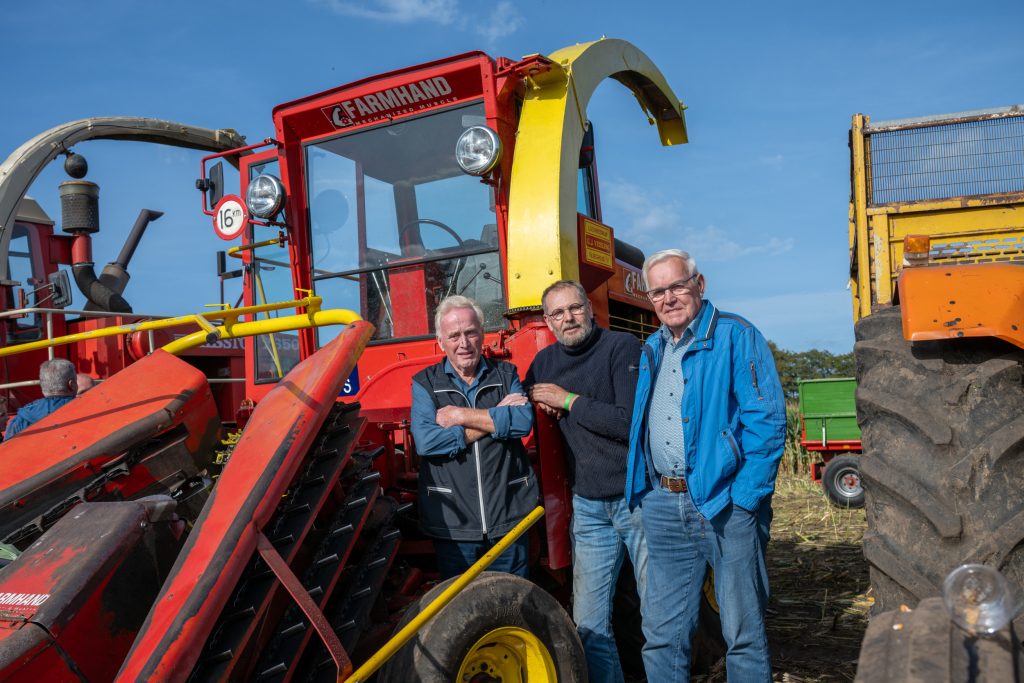 Loonwerker Gerrit Jan Vrieling (links), trekkerliefhebber Wim Lamberts en Gerrit Jan Klaassen (rechts), destijds de vaste chauffeur op de Farmhand F600. De restauratie had nogal wat voeten in aarde. Maar nu alles weer draait, beleven ze er veel plezier aan. Ieder jaar komt de hakselaar een paar keer van stal.